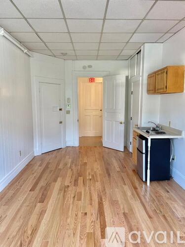 A room with wooden floors and white walls.