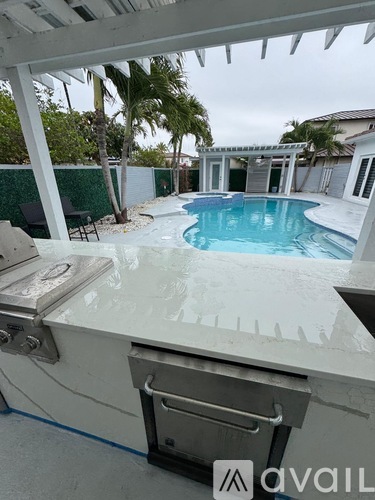 A pool with a hot tub attached to it.