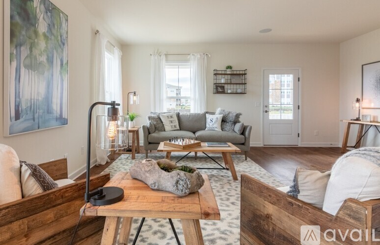A living room with a couch, a coffee table, and a lamp.
