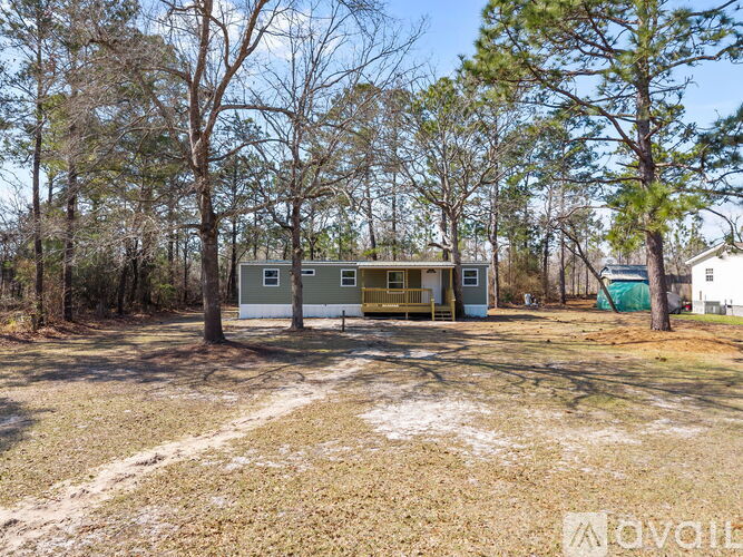 A house is surrounded by trees in a wooded area.