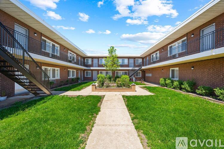 A sunny day at the apartment complex with a clear blue sky.