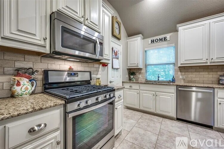 A kitchen with a stove top oven and microwave above it.