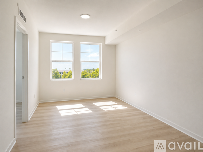 A kitchen with a refrigerator and a white door.