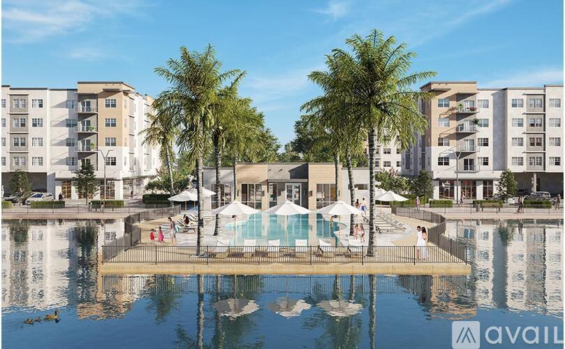 A large building with a pool in front of it.