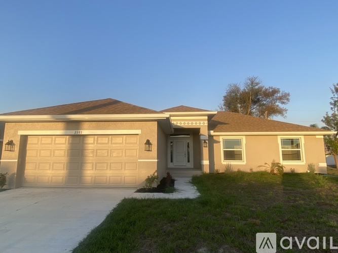 A house with a garage and a driveway is available for sale.