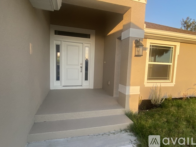 A house with a white door and a window is available for rent.