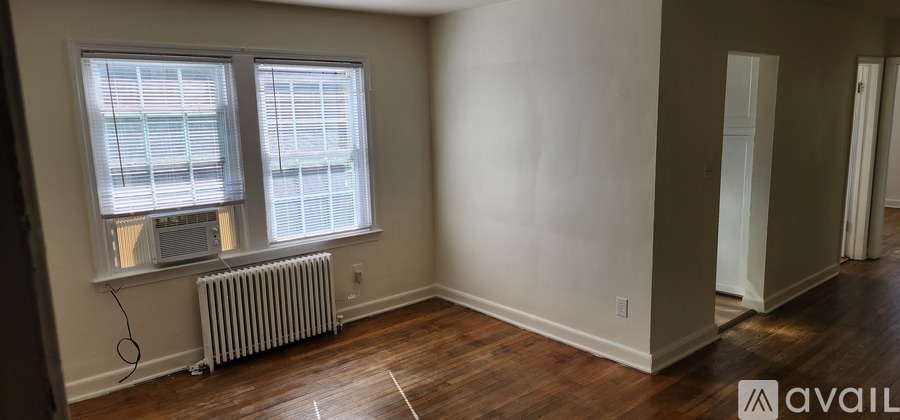 A room with a window and a radiator on the floor.