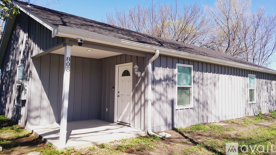 A small building with a door and windows is for sale.