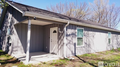A small building with a door and windows is for sale.