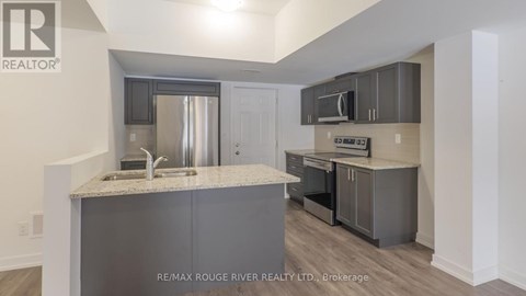 A kitchen with a sink and a microwave.