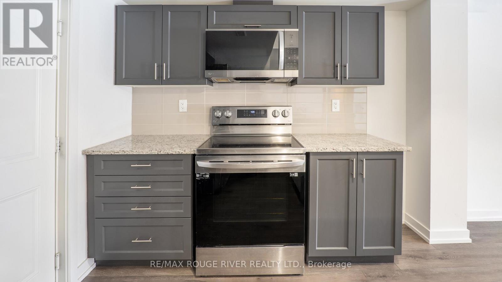 A modern kitchen with a stove top oven and a range hood.