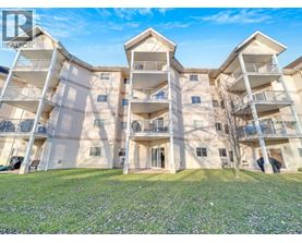 A large apartment complex with multiple balconies and doors.