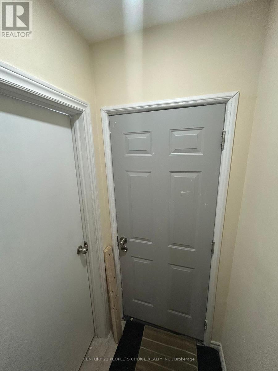 A white door with a black mat in front of it.