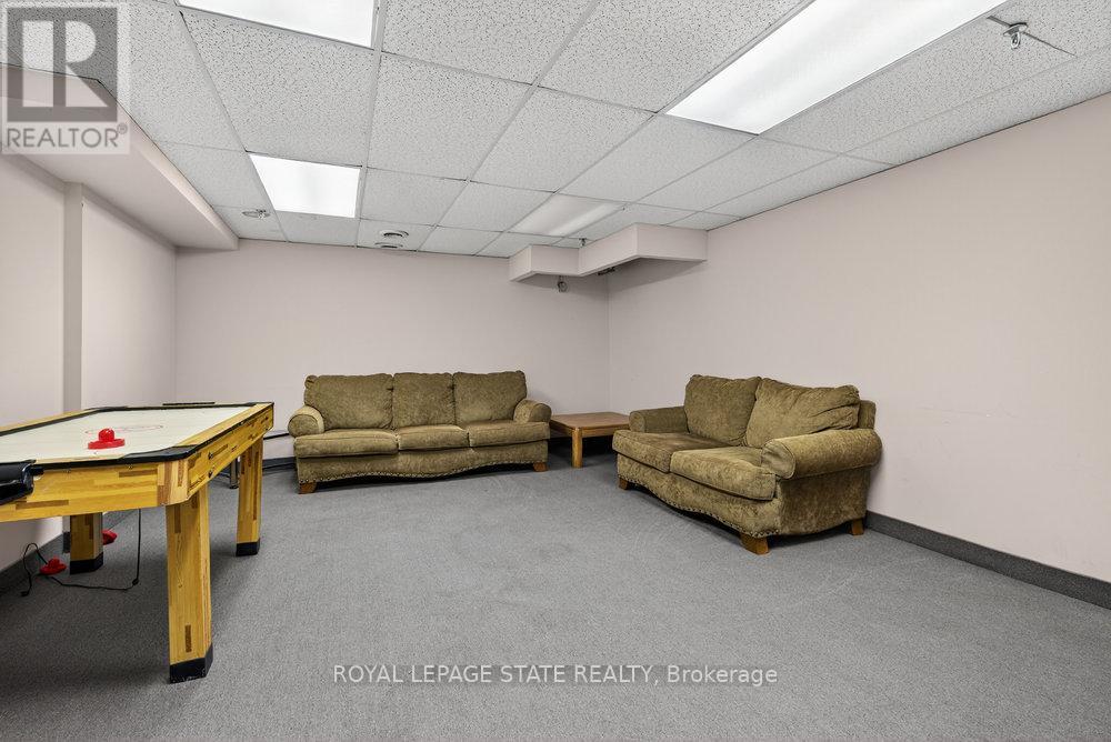 A room with a pool table and two couches.