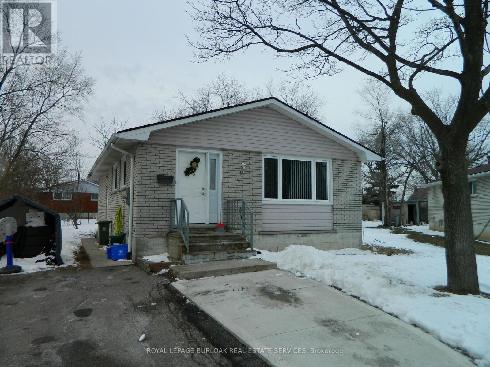 A house with a grey roof and a white door is for sale.