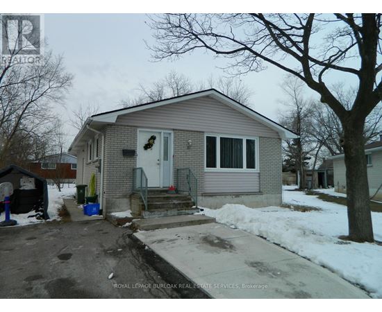A house with a grey roof and a white door is for sale.