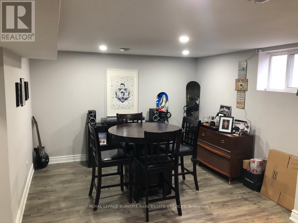 A dining room with a guitar and a skateboard.