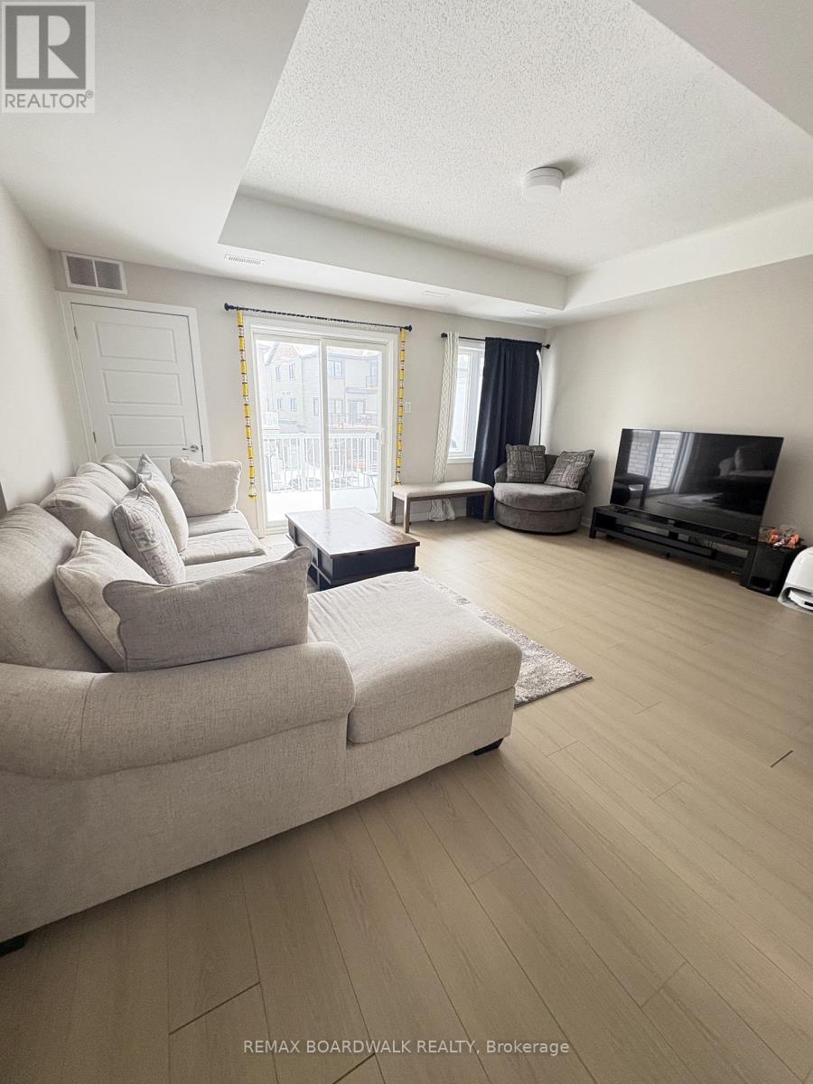 A living room with a couch, a television, and a window with curtains.