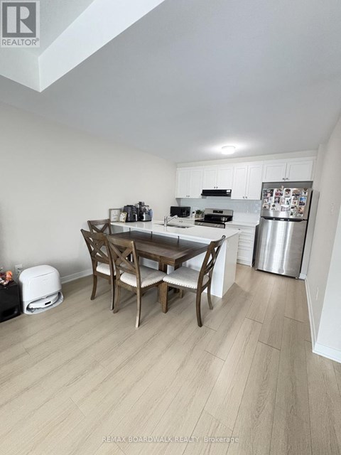 A kitchen with a table and chairs in the middle of the room.