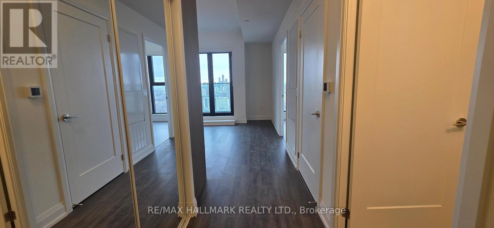 A hallway with a REALTOR sign on the door.