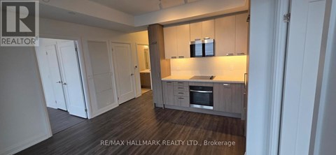 A kitchen with white cabinets and a wooden island.