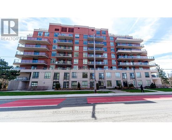A red and white apartment building with a person standing in front.