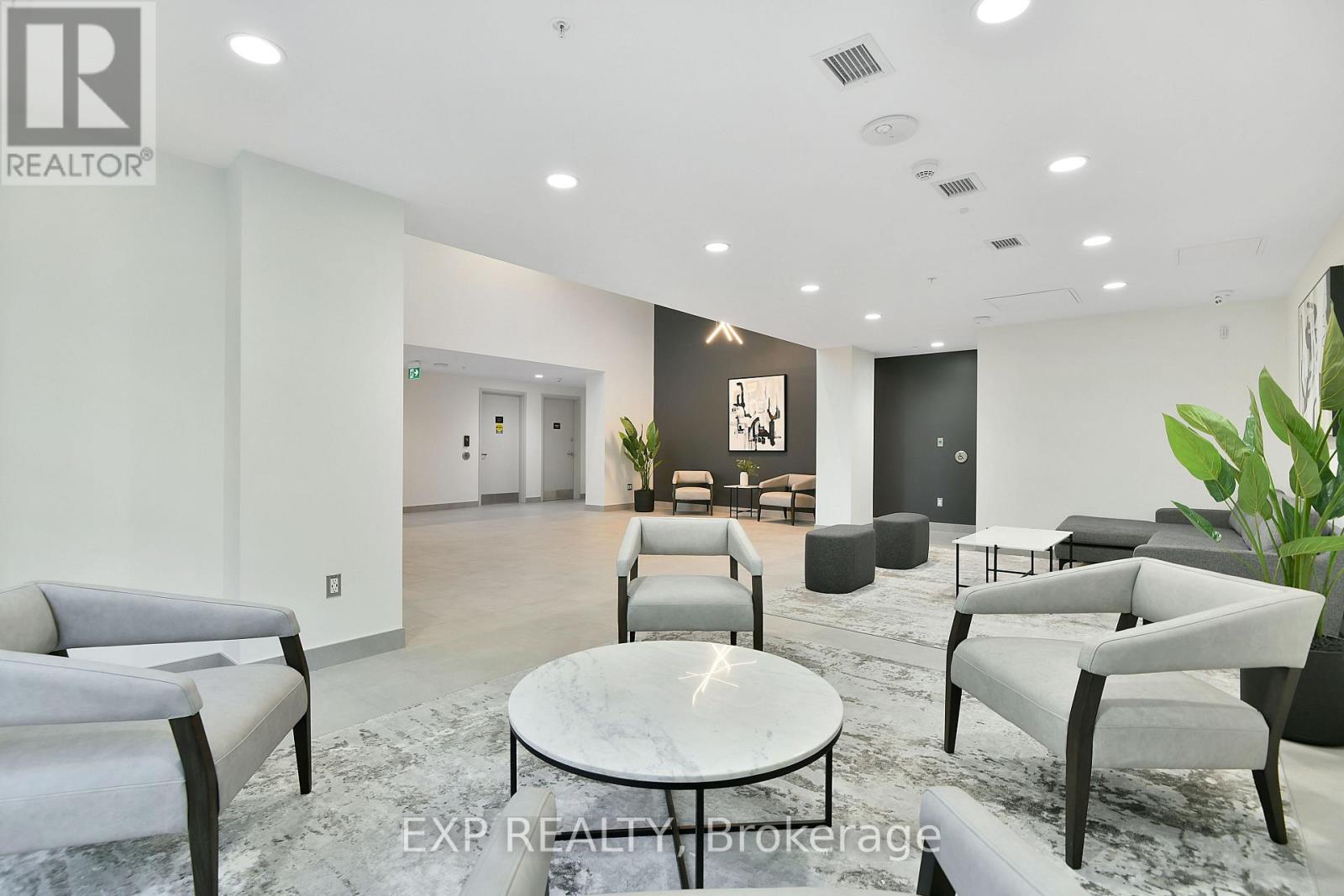 A modern living room with grey furniture and a marble table.