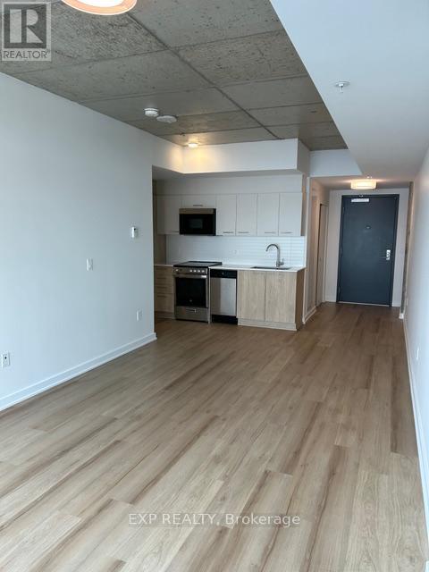 A kitchen with wooden floors and white walls.