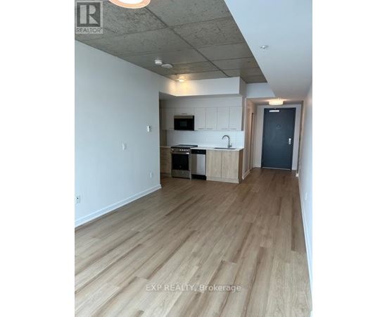 A kitchen with wooden floors and white walls.