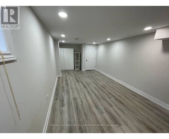 A room with wooden flooring and white walls.