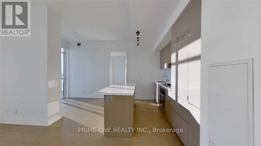 A spacious, empty room with a counter and cabinets.