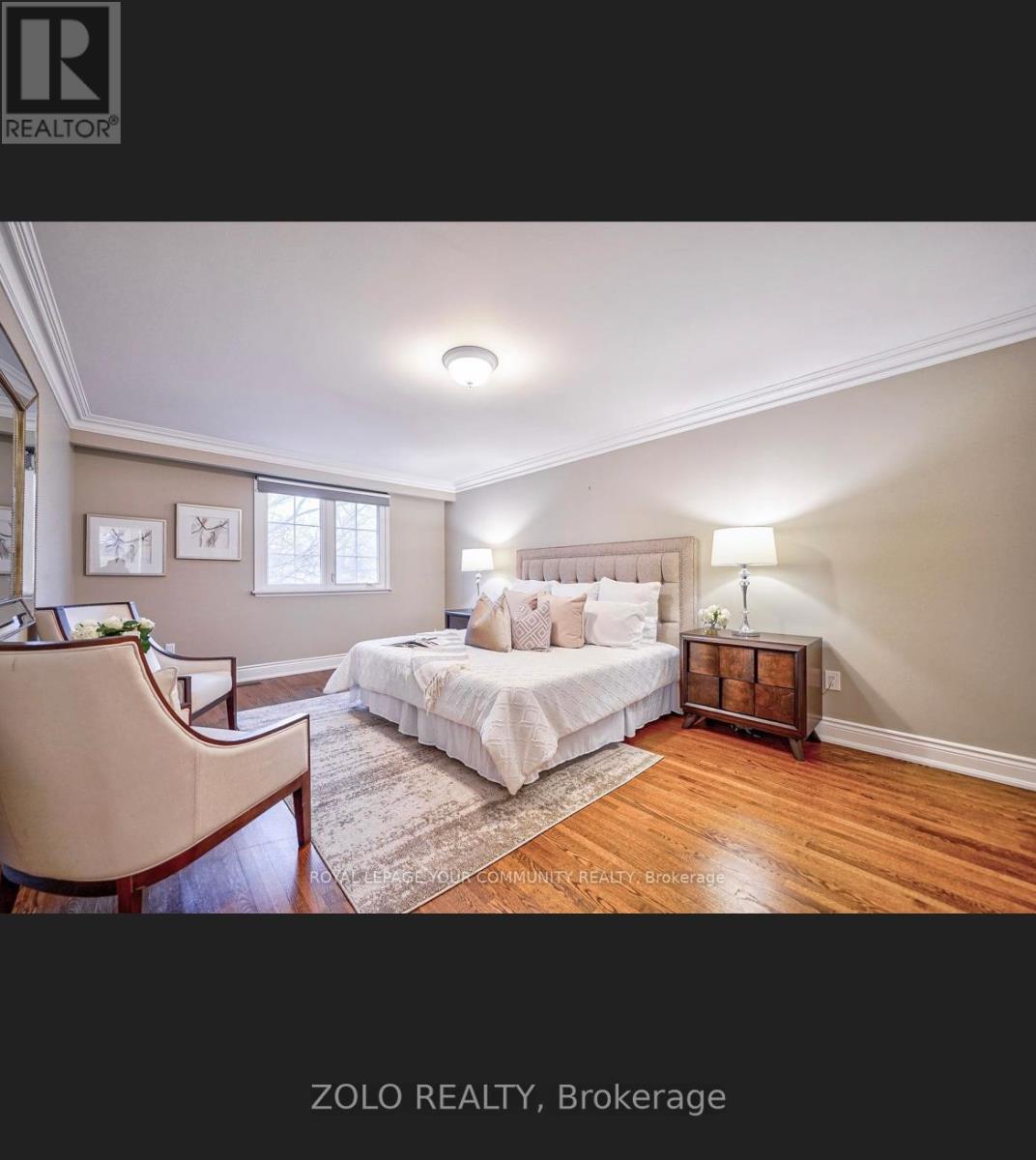 A bedroom with a bed, nightstand, and chair.
