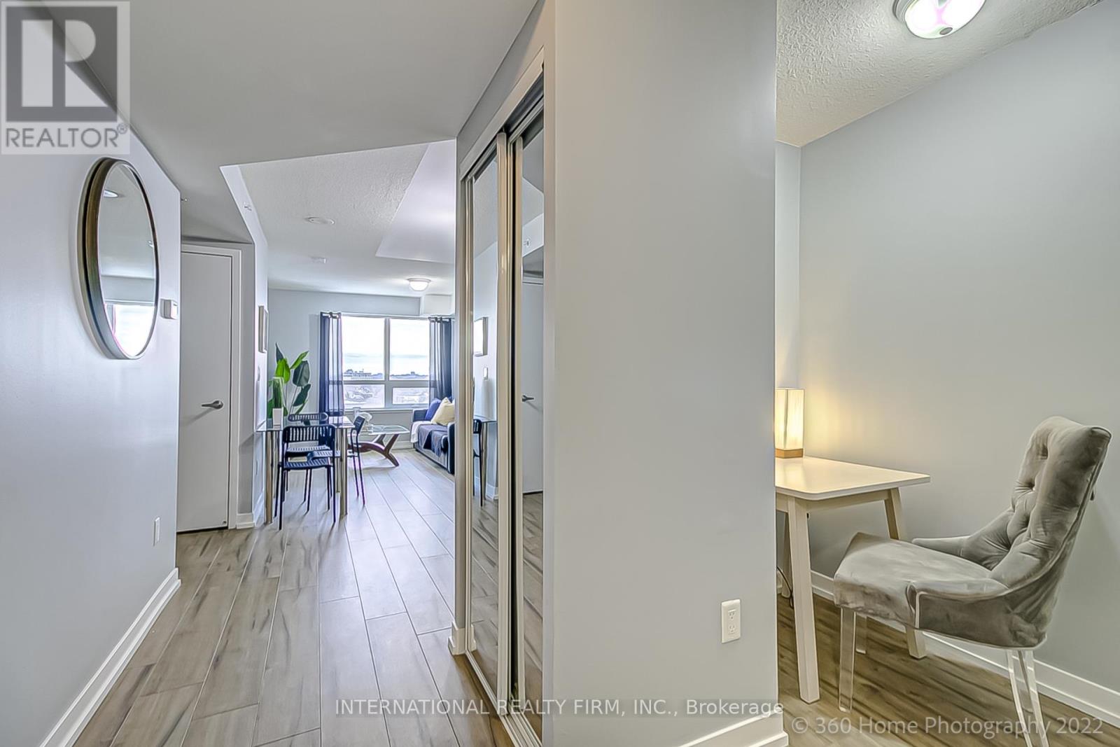 A realtor's photo of a home interior with a dining area and a seating area.