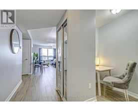 A realtor's photo of a home interior with a dining area and a seating area.