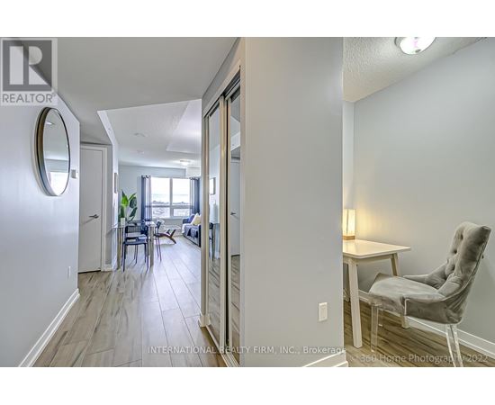 A realtor's photo of a home interior with a dining area and a seating area.