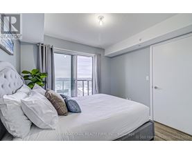 A bedroom with a large bed and a view of the balcony.