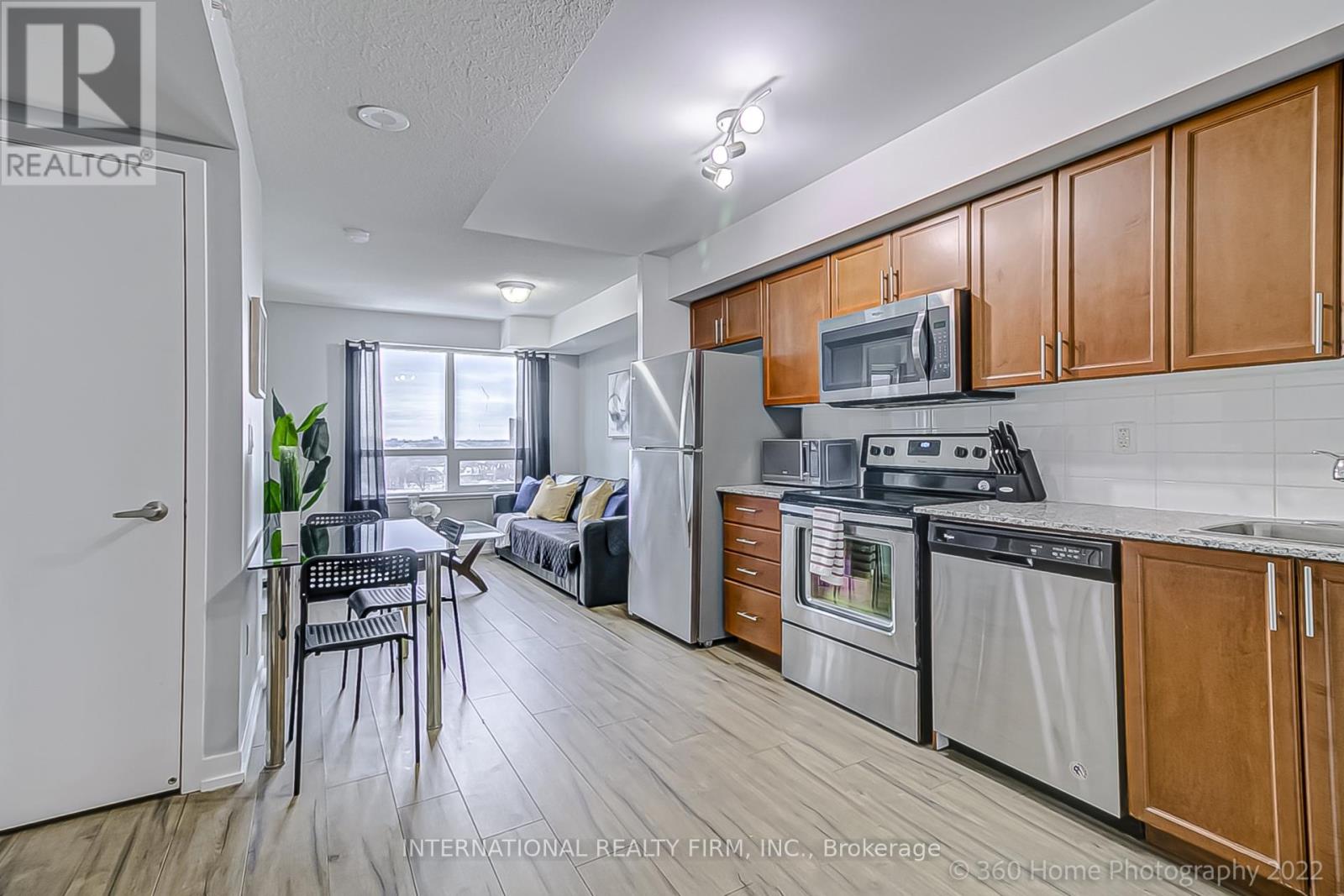 A kitchen with wooden cabinets and stainless steel appliances.
