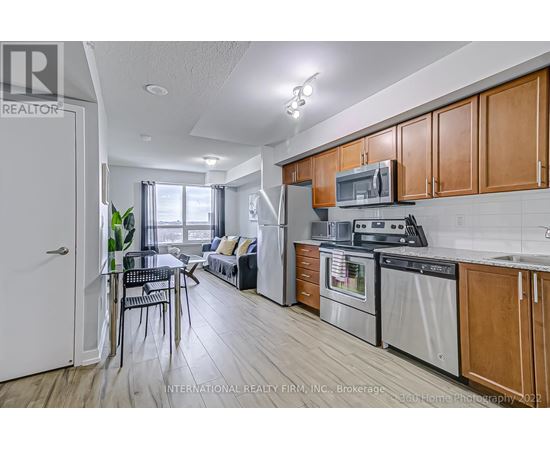 A kitchen with wooden cabinets and stainless steel appliances.