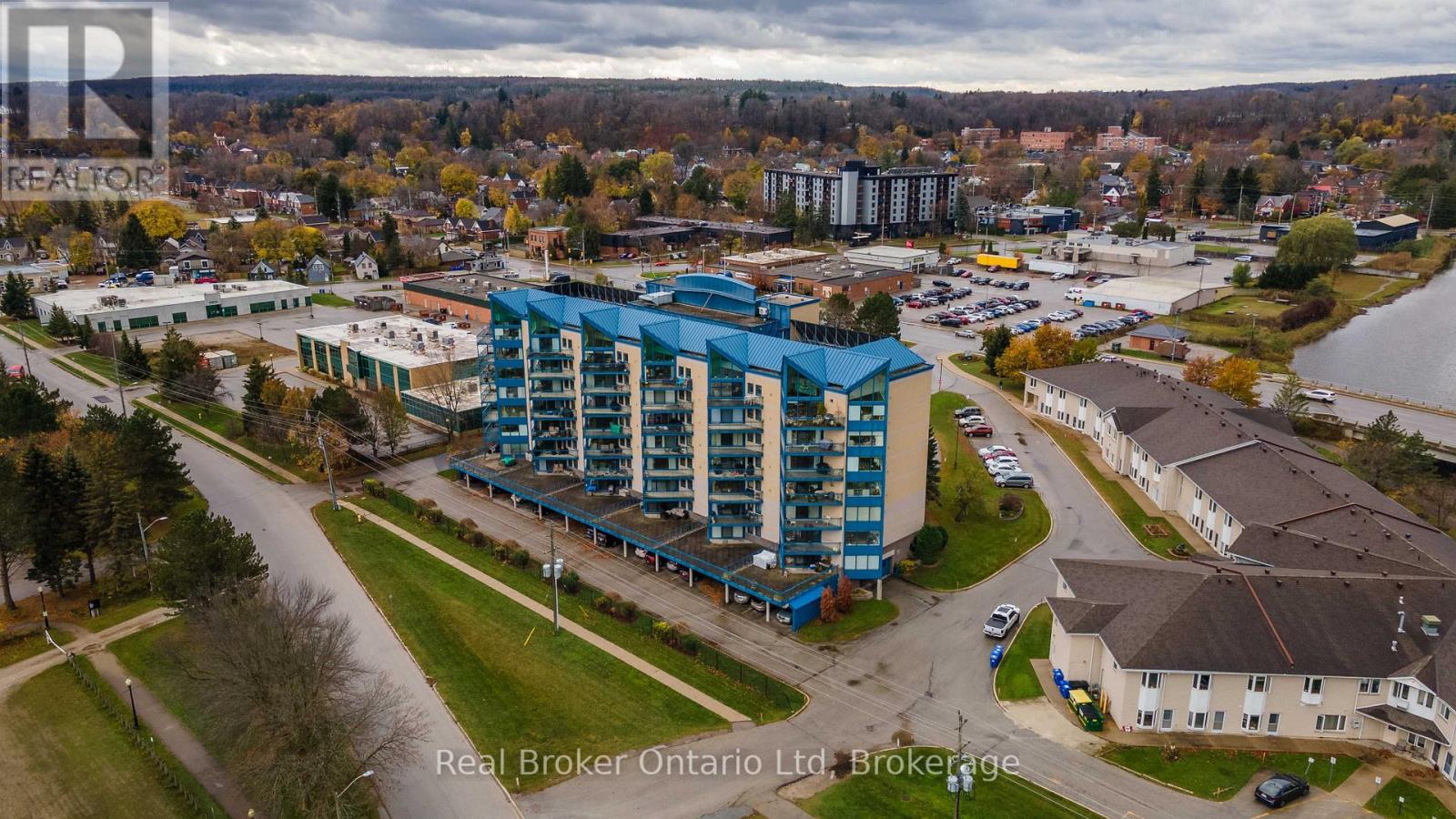 A real estate company's brochure featuring a photograph of a residential area with apartment buildings and houses.
