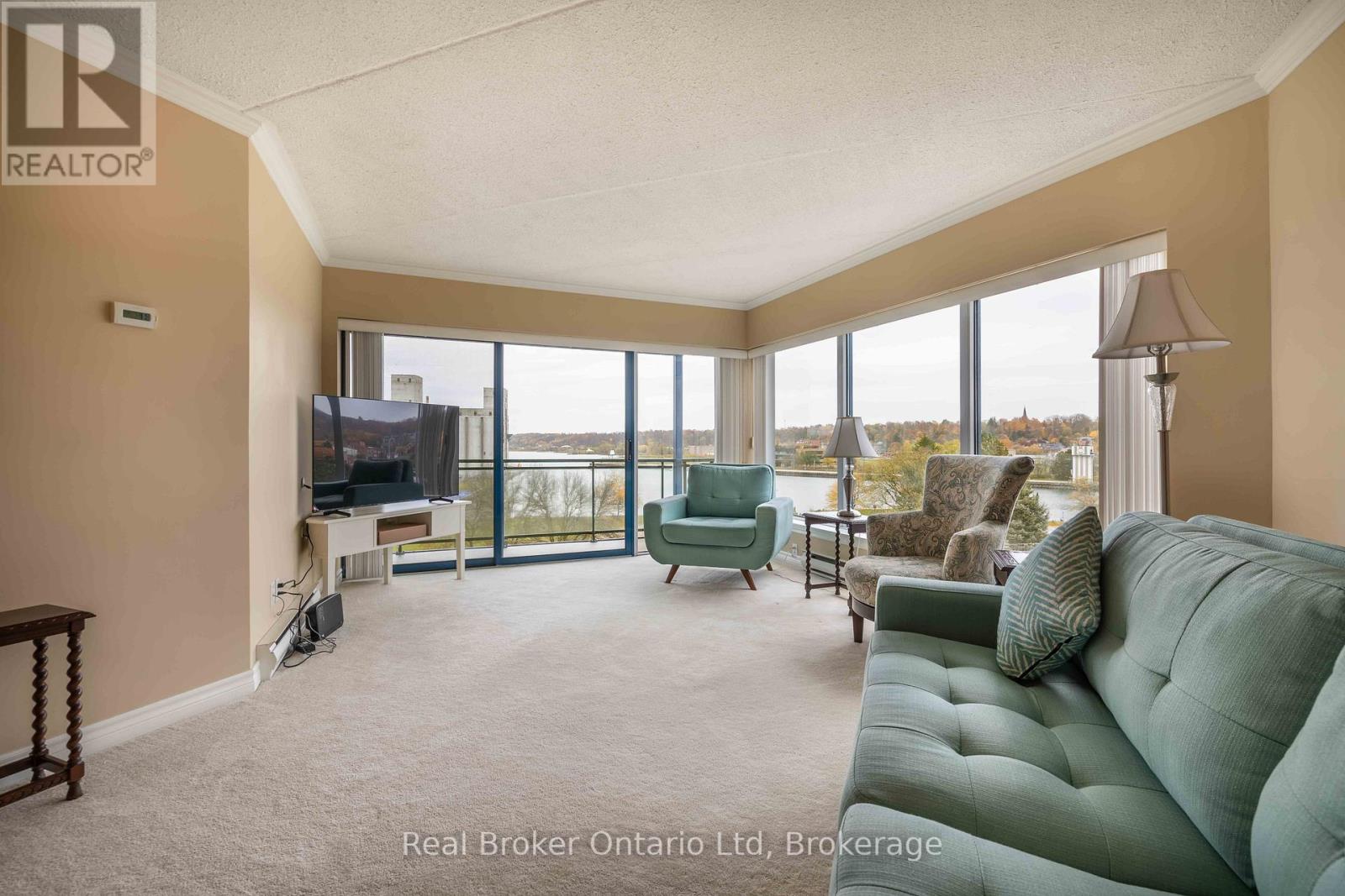 A living room with a green couch and a television.