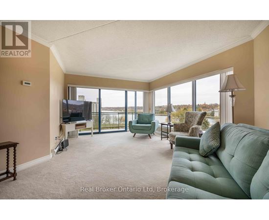 A living room with a green couch and a television.