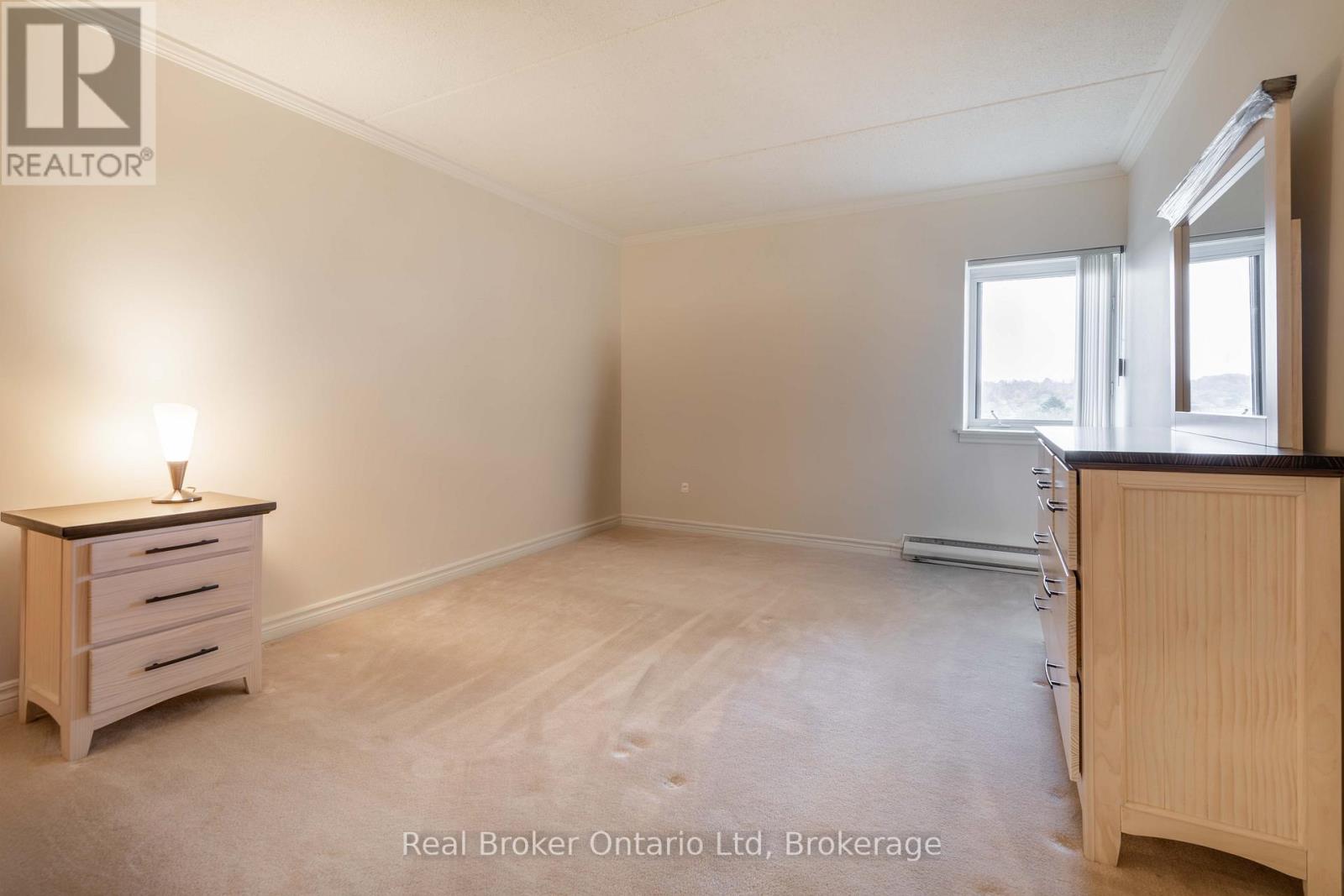 A bedroom with a dresser and a window.