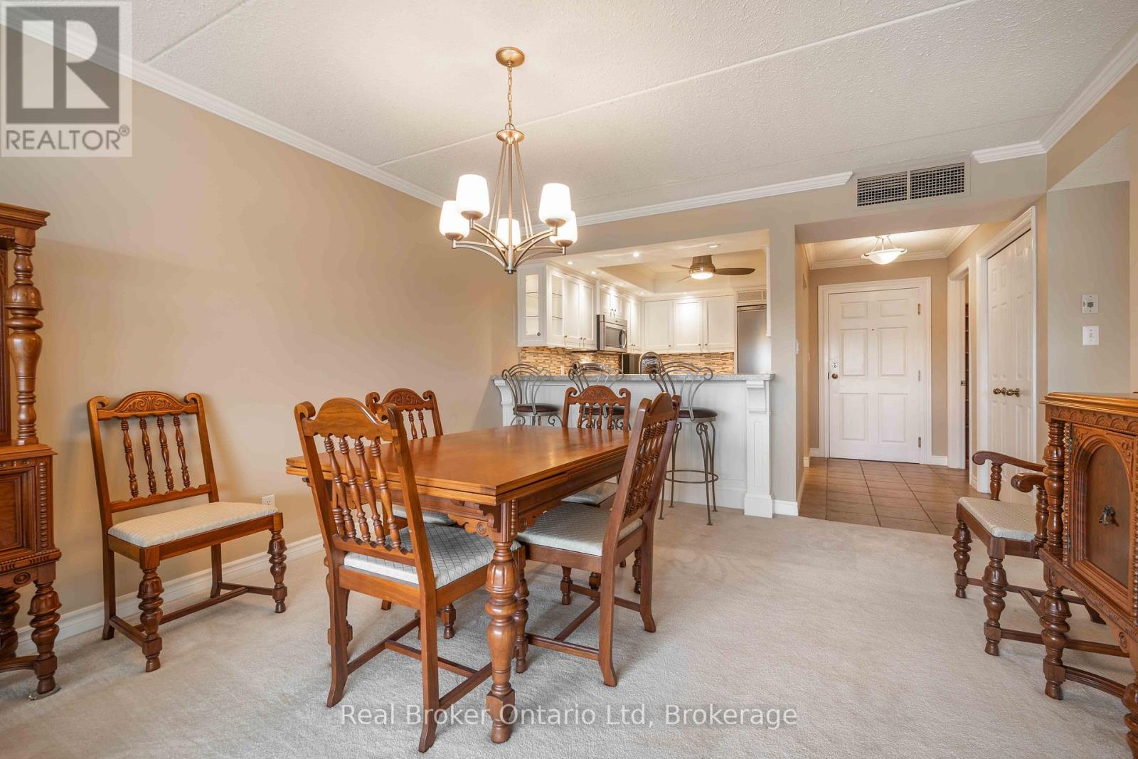 A dining room with a wooden table and chairs.
