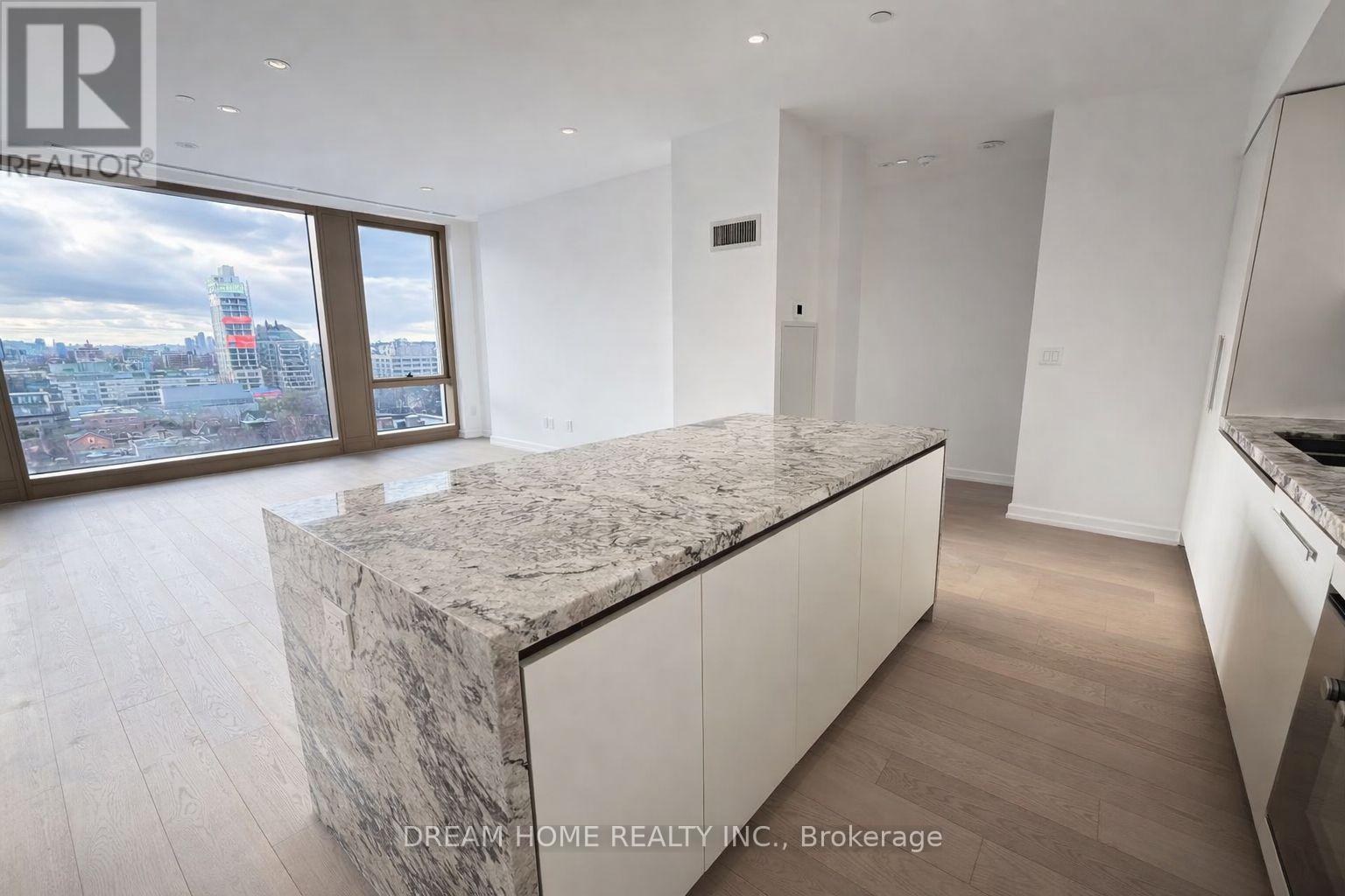A marble countertop in a modern kitchen with a view of the city.