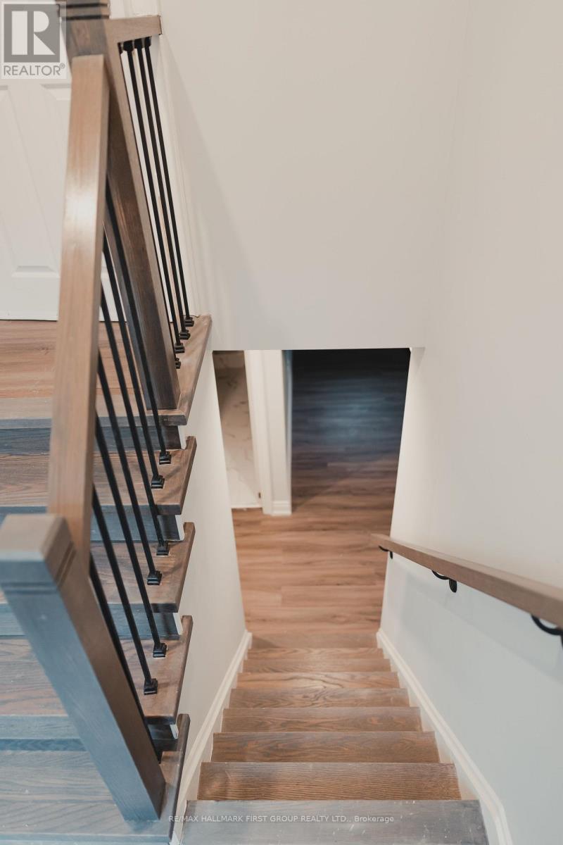 A staircase with a wooden handrail and steps.