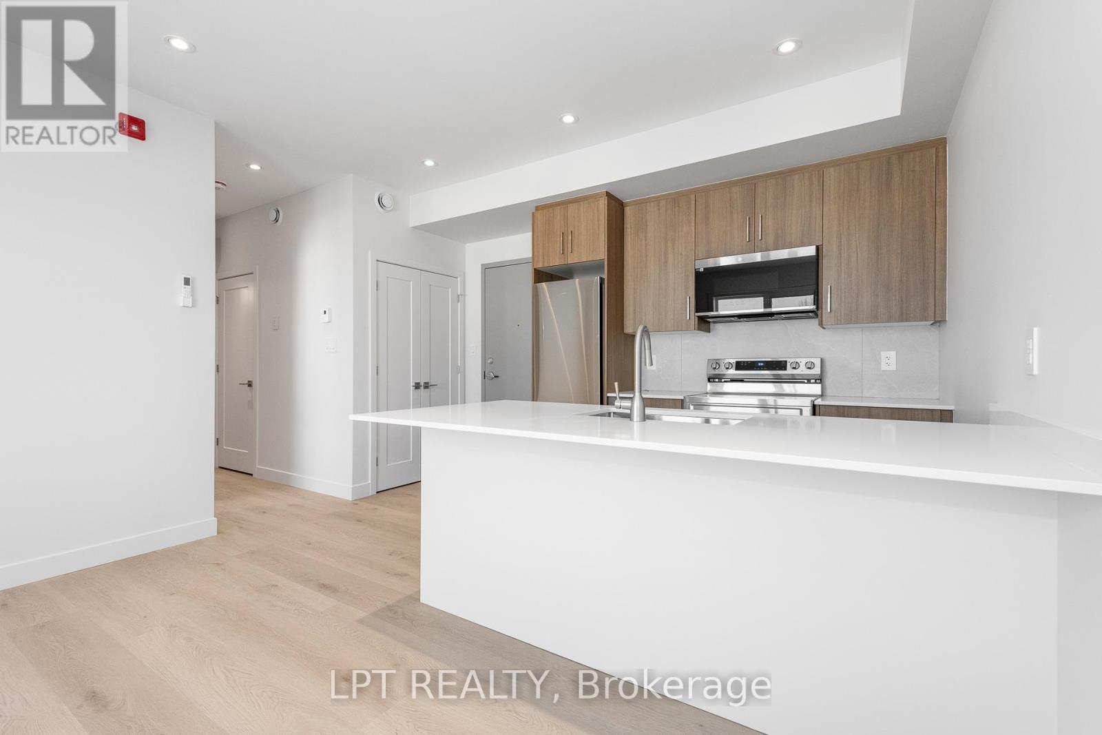 A modern kitchen with wooden cabinets and stainless steel appliances.