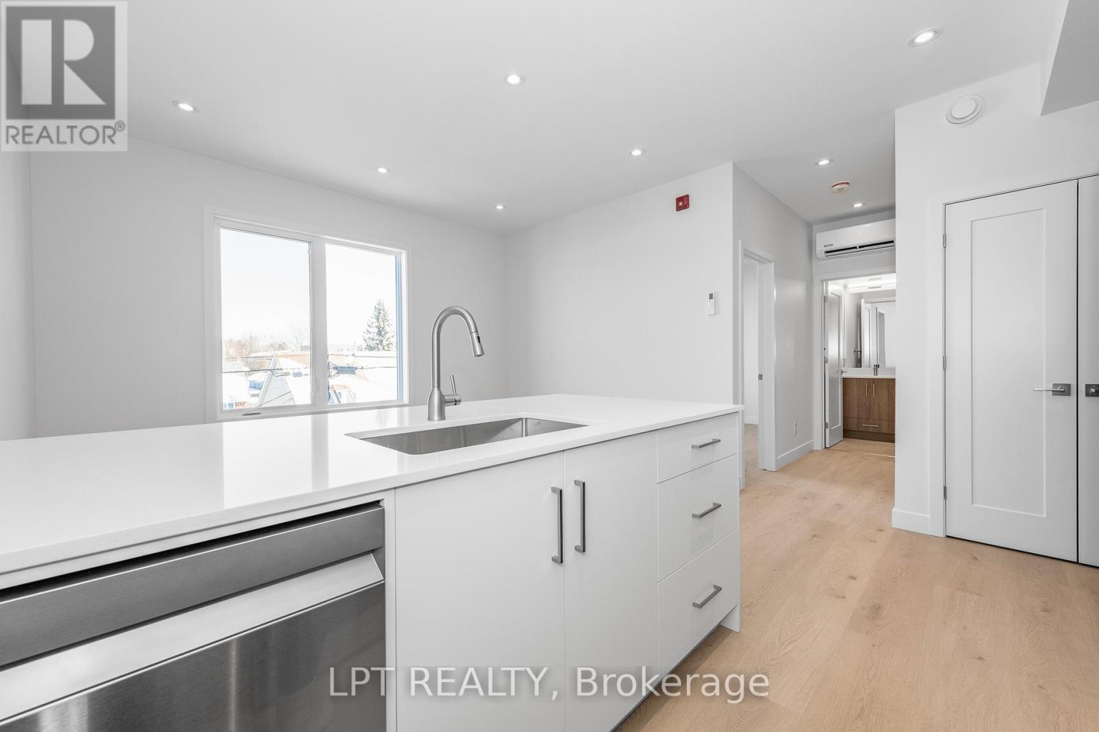 A modern kitchen with white cabinets and a large island.