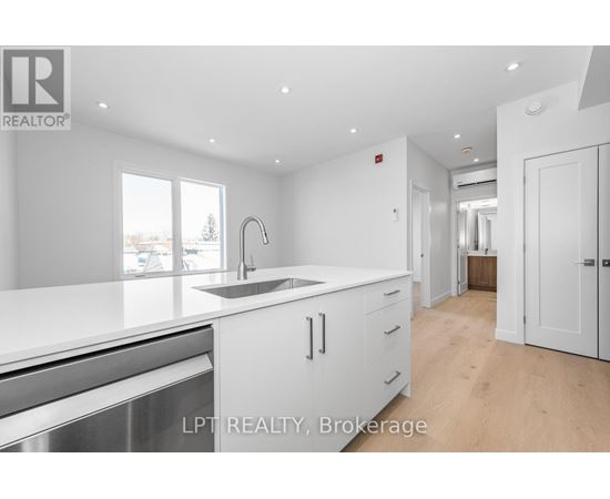A modern kitchen with white cabinets and a large island.