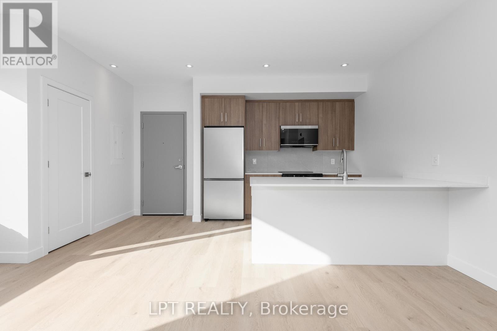A modern kitchen with wooden cabinets and stainless steel appliances.