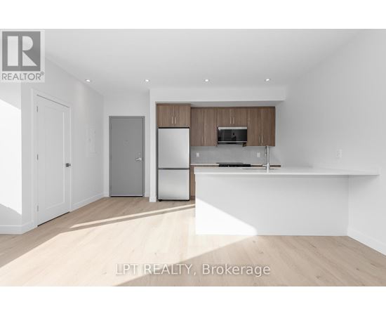 A modern kitchen with wooden cabinets and stainless steel appliances.